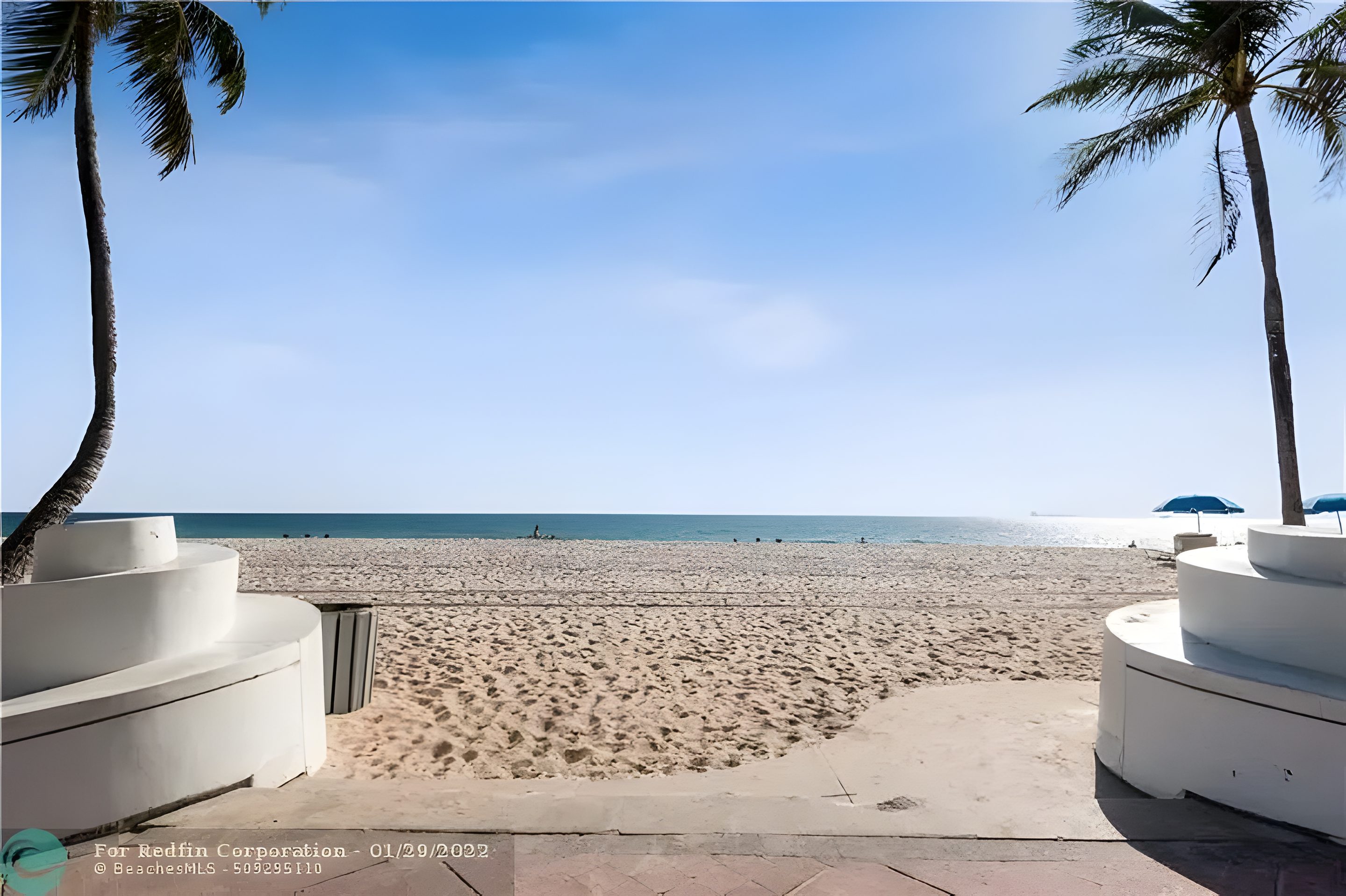The beach at the end of Terramar Street, the sand and the low sea wall.