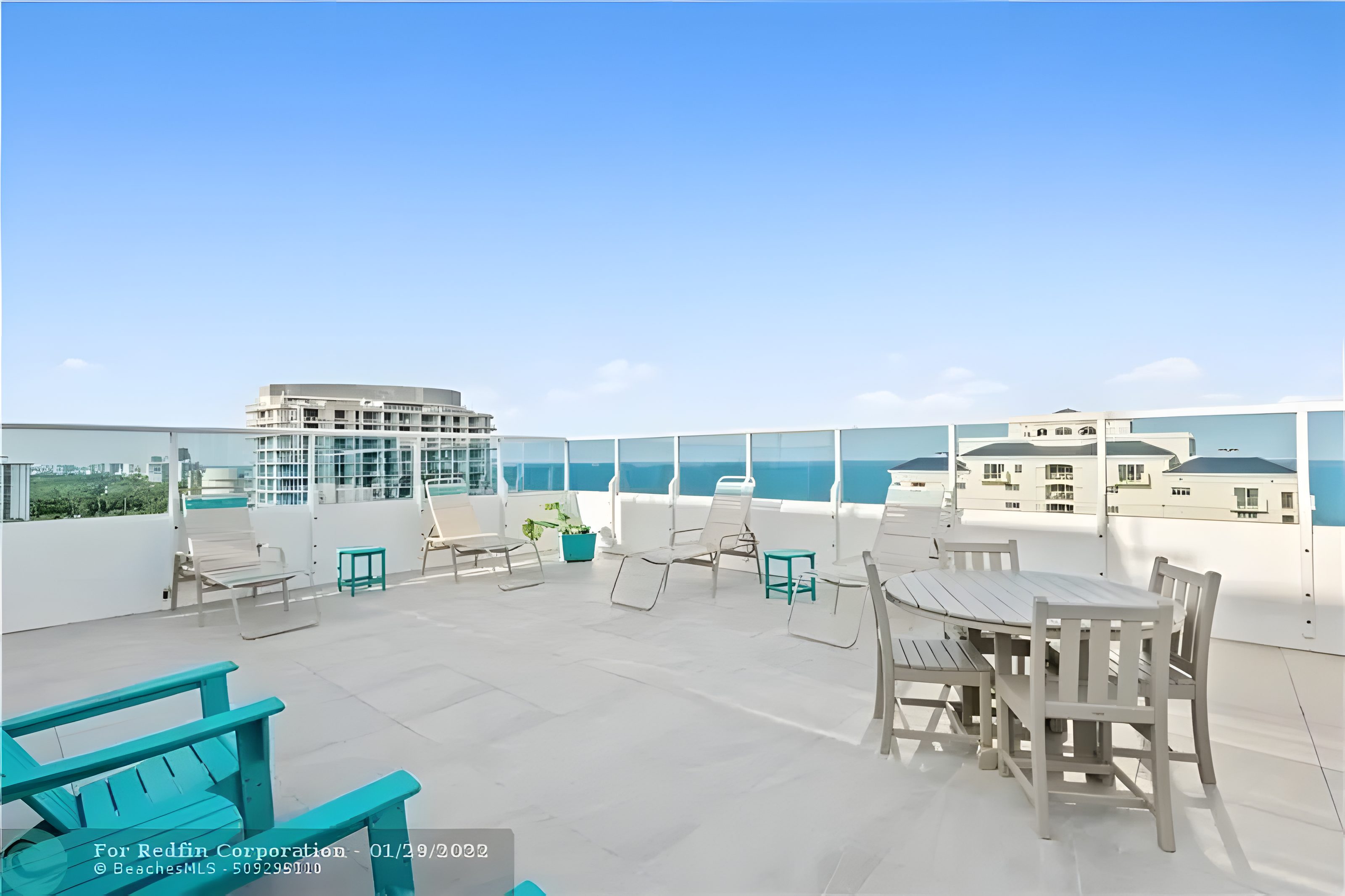 The rooftop sun deck at Birch Tower, loungers along the rail and the Atlantic beyond.